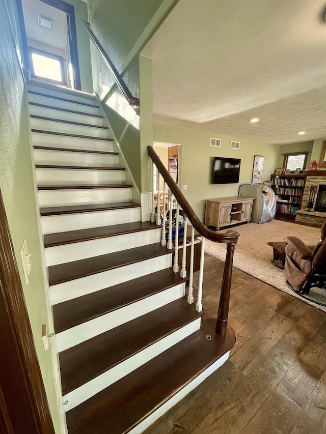 stairway with hardwood / wood-style floors and a wealth of natural light