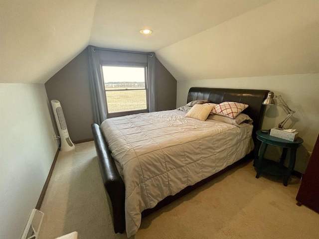 bedroom with vaulted ceiling and light carpet