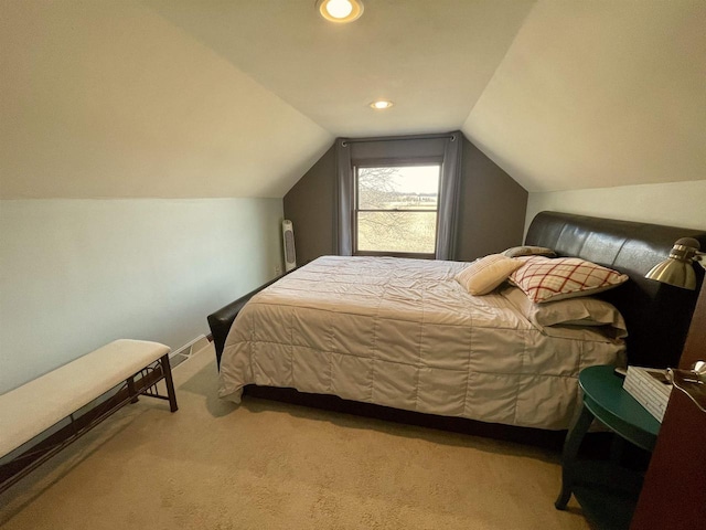 bedroom with lofted ceiling, radiator, and light colored carpet