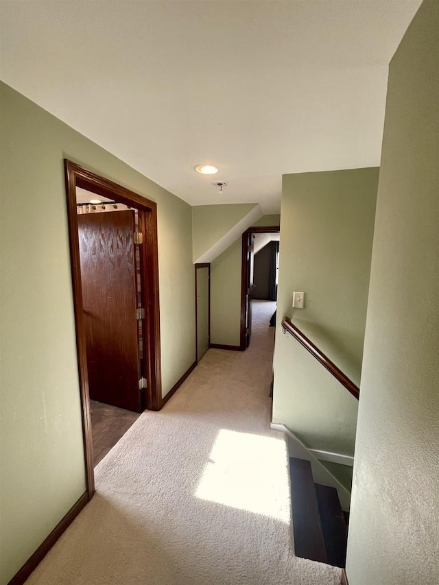 corridor featuring light colored carpet