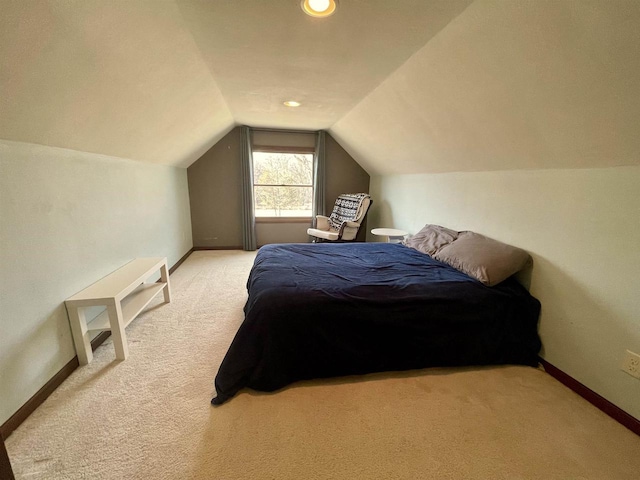 bedroom featuring vaulted ceiling and light colored carpet