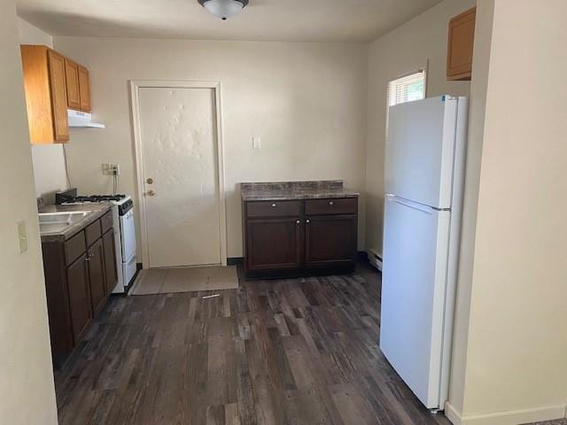 kitchen with dark hardwood / wood-style flooring, white appliances, and ventilation hood