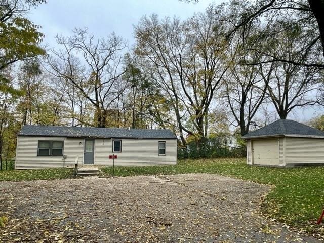 exterior space featuring an outbuilding and a garage