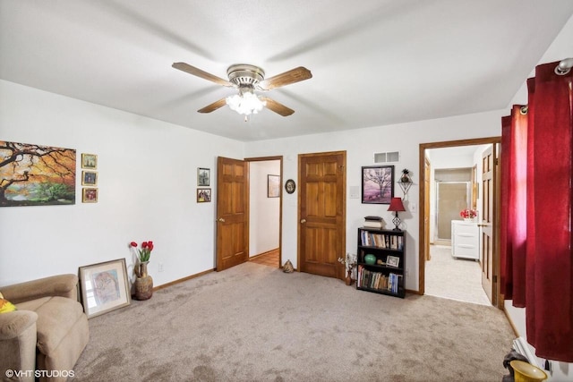 interior space featuring light carpet and ceiling fan