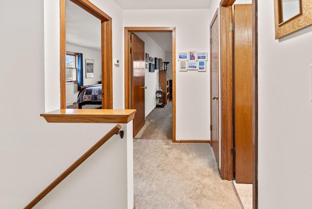 hallway featuring light carpet