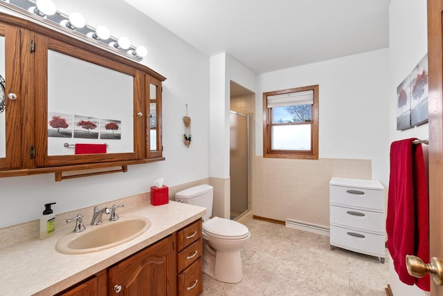 bathroom featuring vanity, a baseboard heating unit, toilet, and an enclosed shower