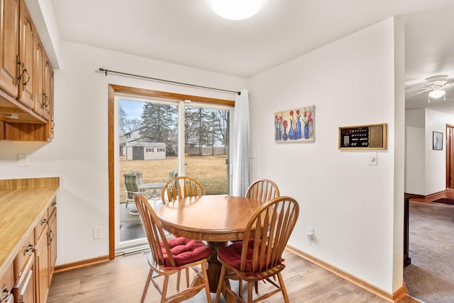 dining space featuring ceiling fan and light hardwood / wood-style floors