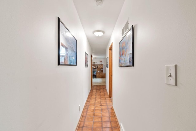 hallway with tile patterned floors