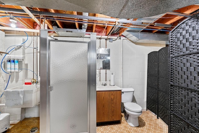 bathroom featuring vanity, a shower with shower door, and toilet