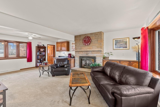 living room featuring light colored carpet, a fireplace, and a baseboard radiator