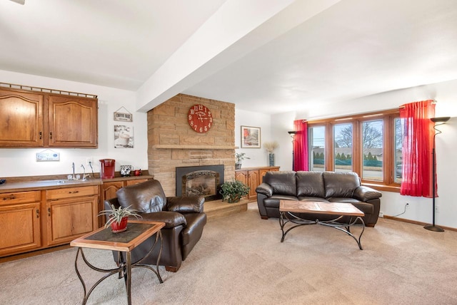 living room with sink, light colored carpet, and a fireplace