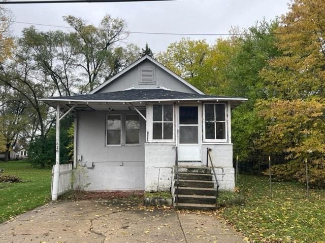 rear view of house with a lawn