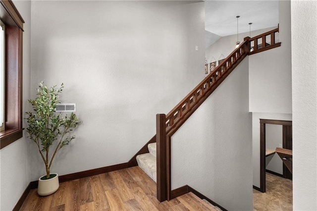 staircase with hardwood / wood-style floors