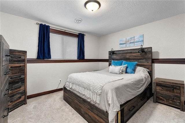 carpeted bedroom with a textured ceiling