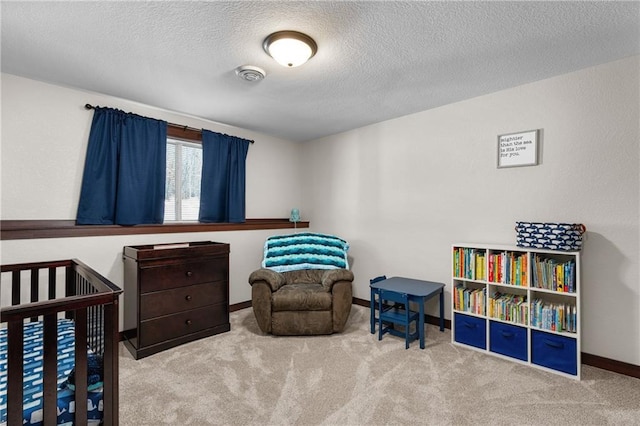 bedroom featuring light carpet and a textured ceiling