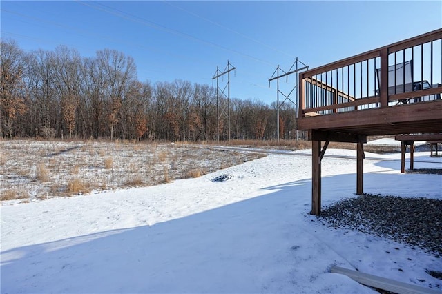 yard covered in snow with a wooden deck