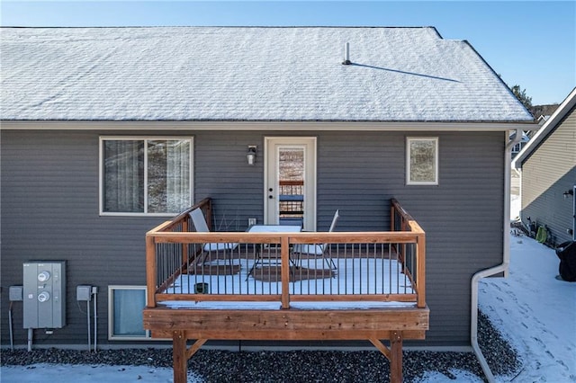 snow covered property featuring a wooden deck