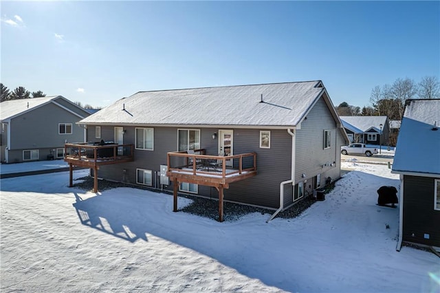 snow covered property with a deck