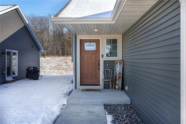 view of snow covered property entrance