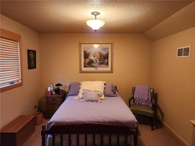 carpeted bedroom with vaulted ceiling and a textured ceiling