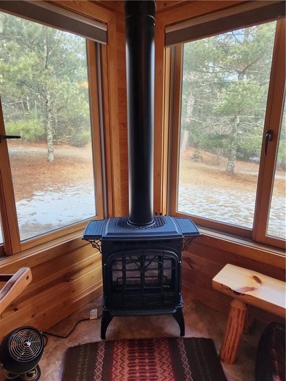 details with wooden walls and a wood stove