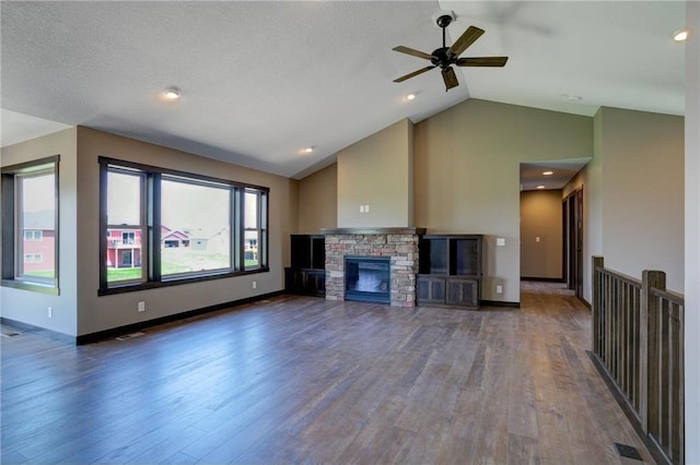 unfurnished living room featuring ceiling fan, high vaulted ceiling, hardwood / wood-style floors, and a fireplace