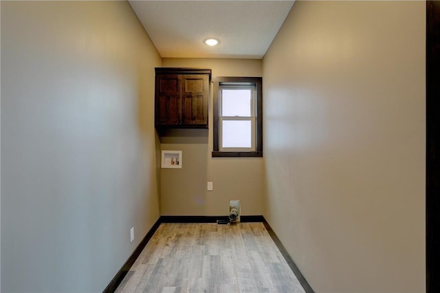 laundry room featuring washer hookup and light hardwood / wood-style floors