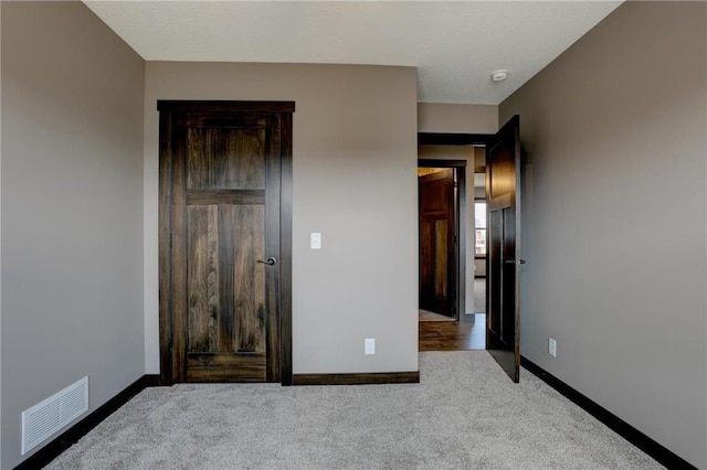 unfurnished bedroom featuring light colored carpet