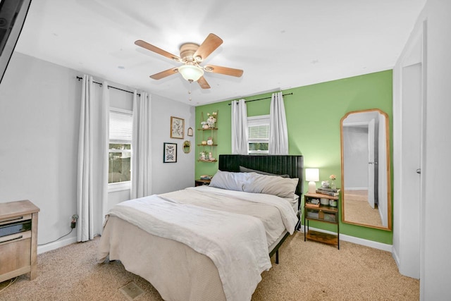 bedroom featuring light colored carpet and ceiling fan