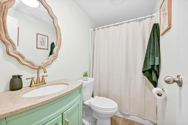 bathroom featuring vanity, hardwood / wood-style floors, and toilet