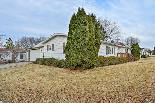 view of home's exterior featuring a garage and a lawn