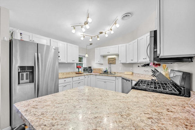 kitchen with white cabinetry, appliances with stainless steel finishes, and kitchen peninsula