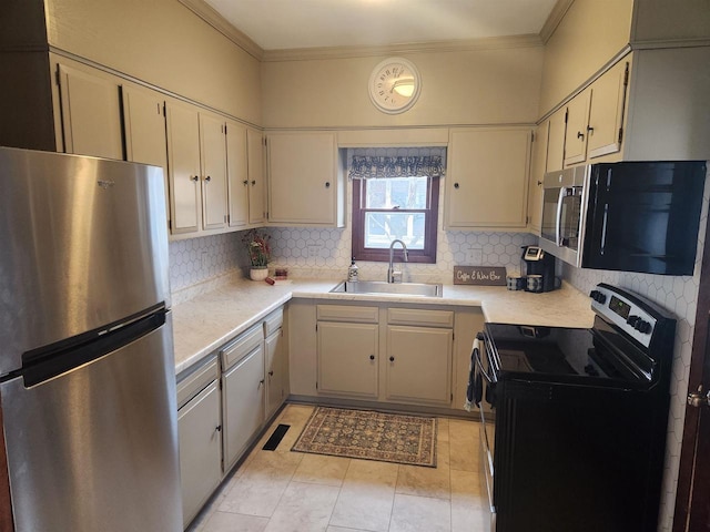 kitchen with ornamental molding, appliances with stainless steel finishes, sink, and decorative backsplash