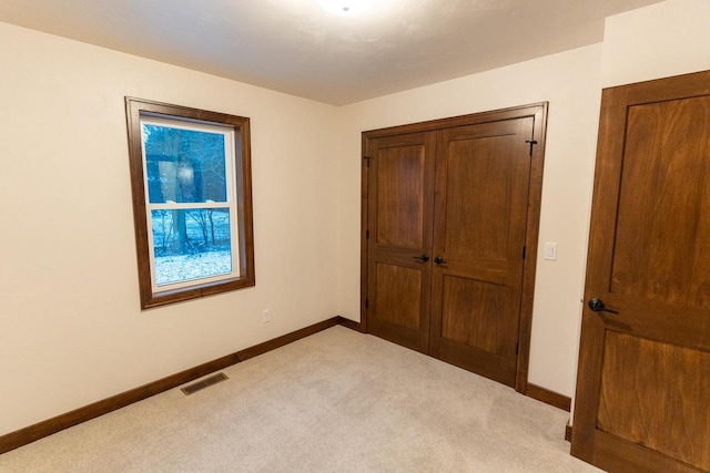 unfurnished bedroom with light carpet