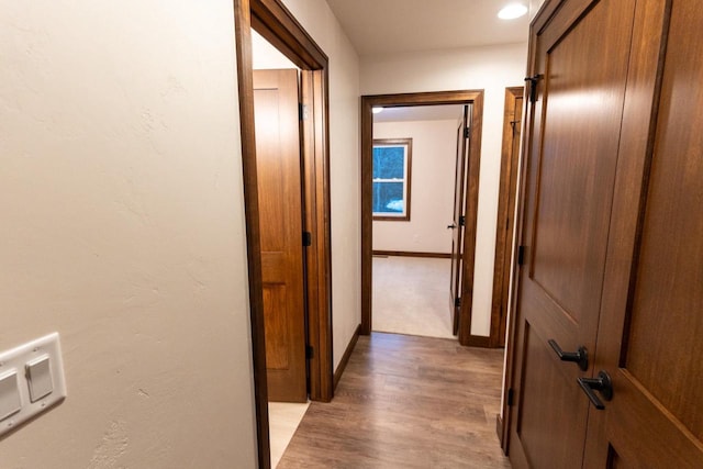 corridor with light wood-type flooring