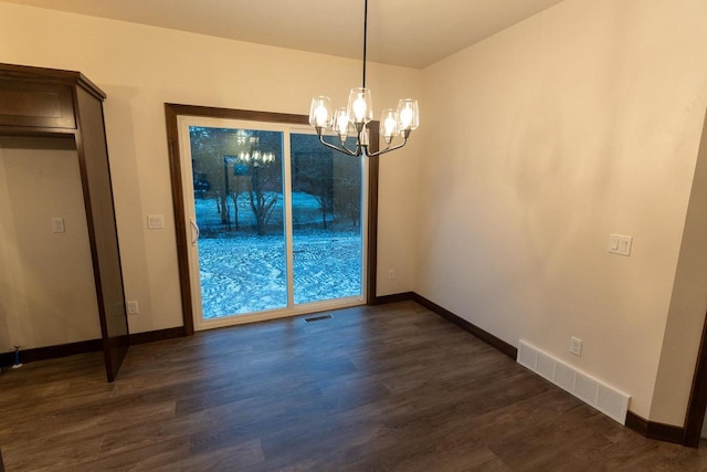 unfurnished dining area with dark wood-type flooring and a chandelier