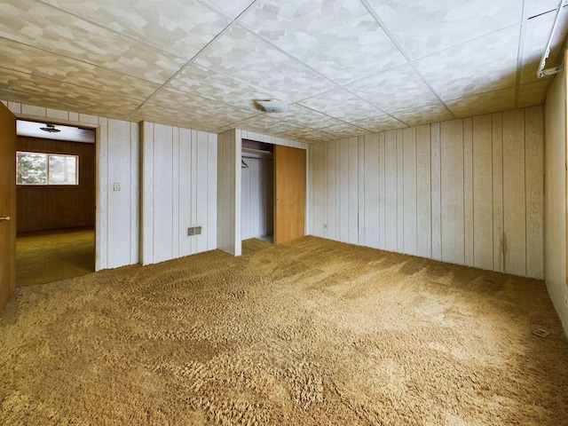 basement with wood walls and carpet