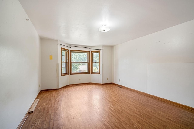 unfurnished room featuring hardwood / wood-style floors