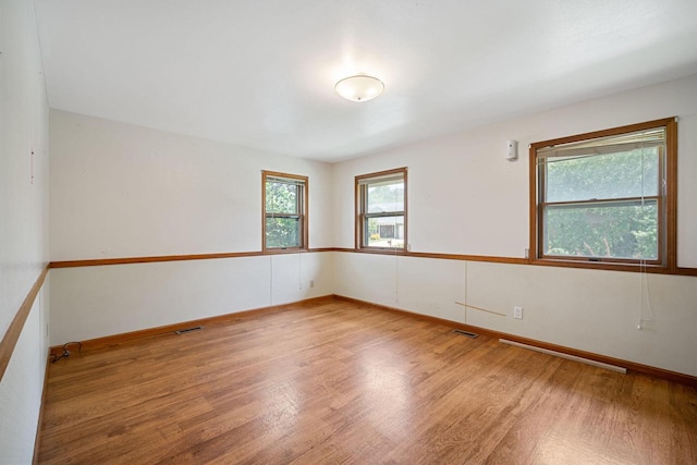 spare room featuring light hardwood / wood-style flooring