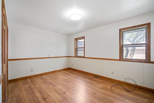 unfurnished room with light hardwood / wood-style floors