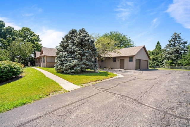 view of front of home with a garage and a front lawn