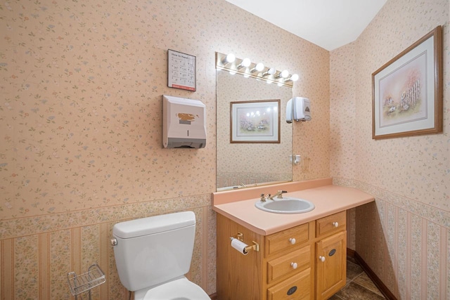 bathroom with tile patterned flooring, vanity, and toilet