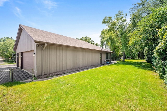 view of side of property featuring a yard and a garage