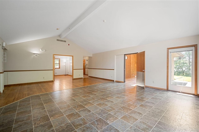 empty room with wood-type flooring, beam ceiling, and high vaulted ceiling