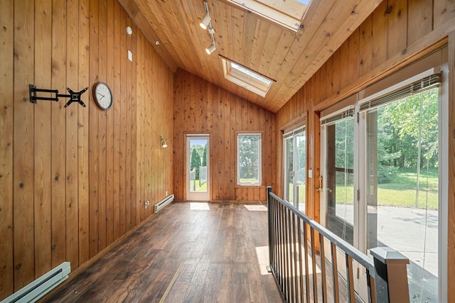 unfurnished sunroom featuring wood ceiling, lofted ceiling with skylight, and a baseboard heating unit