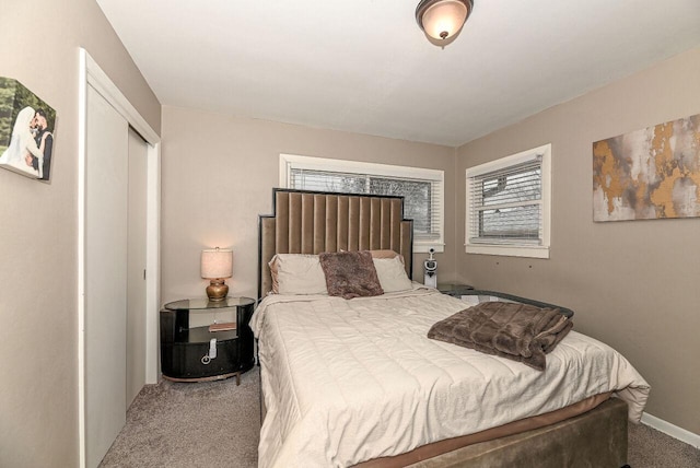 carpeted bedroom featuring a closet and multiple windows