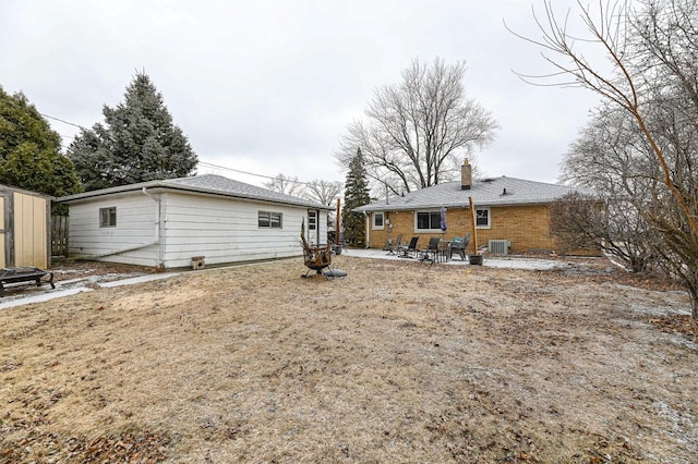 rear view of property with central air condition unit and a patio area