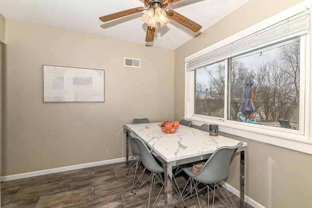 dining space with dark hardwood / wood-style flooring and ceiling fan