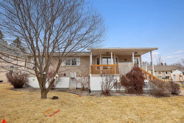 back of property featuring a lawn and a porch