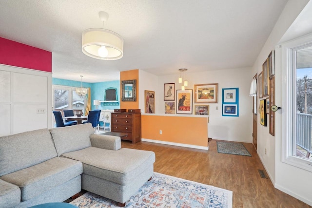 living room with hardwood / wood-style floors and a notable chandelier